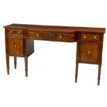 A 19th Century mahogany breakfront Sideboard, with one long and two small frieze drawers above two