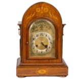 An inlaid mahogany chiming Mantle Clock, 20th Century, with arched case and brass dial with Arabic