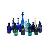 A collection of 19th Century coloured glass Decanters and Spirit Bottles, comprising a pair of