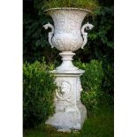 A large heavy set of 4 unusual cast iron Garden Urns, each relief cast with vases of flowers and two