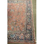 A large pink ground Middle Eastern Carpet, with central panel decorated with geometric and floral