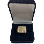 A South African 9ct gold Gentleman's Signet Ring, with a .06ct, 2.5mm diamond inset, approx. 9.8