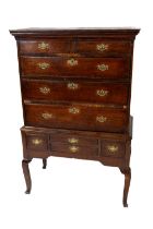 A late 18th Century oak Chest on Stand, the moulded cornice above an arrangement of three long and