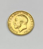 Coins: A 1913 King George V half Sovereign, good. (1)