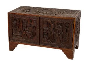 A carved Chinese camphor-wood Chest, c. 1900, the top carved profusely with a Chinese battle scene