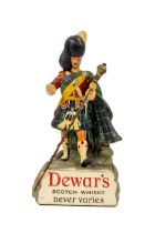Advertisement: Dewars - Scotch Whisky Never Varies, model of a Scottish Highlander, together with