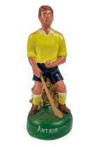 G.A.A.: a hand painted plaster Figure of a hurler "Antrim,"  in crouched position with sliotar and