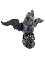 A carved wooden Eagle Crest, with chicks and outstretched later wings, 33cms (13"). (1)