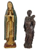 A small carved oak Figure of the Virgin & Child, 18cms (7"); together with another larger carved