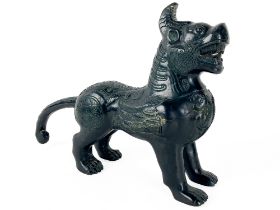 A Chinese bronze Figure of a Foo Lion, with snarling mouth and scrolling tail, 30cms (12"). (1)