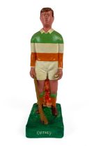 G.A.A.: a hand painted plaster Figure of a hurler "Offaly" in upright position holding sliotar and