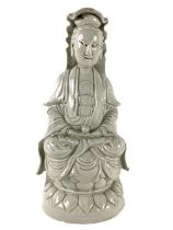 A large Chinese blanc de chine seated Figure of Guanyan, on a lotus base, 37cms high (14 1/2"). (1)