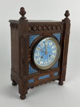 An Aesthetic movement oak striking Mantel Clock, in the Gothic manner with acorn finials and a