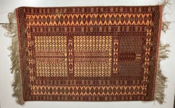 A large Turkoman Prayer Rug, silk and wool with intricate geometric pattern in iron red and cream,