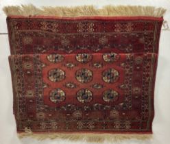 A fine large Bokhara Rug, the burgundy ground with three rows of octagons inside a conforming