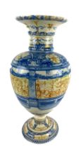 A Majolica Urn, of circular baluster form with flared rim, the body decorated with Renaissance style