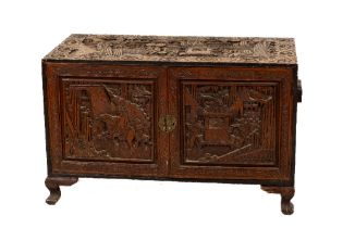 A good antique Chinese carved camphor-wood Chest, c. 1900 profusely carved with ceremonial scenes