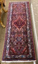 An attractive Middle Eastern woollen Carpet Runner, the salmon and red ground centre with large