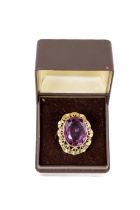 A Ladies 9ct gold Ring, of unusual design with central amethyst type oval stone surrounded by