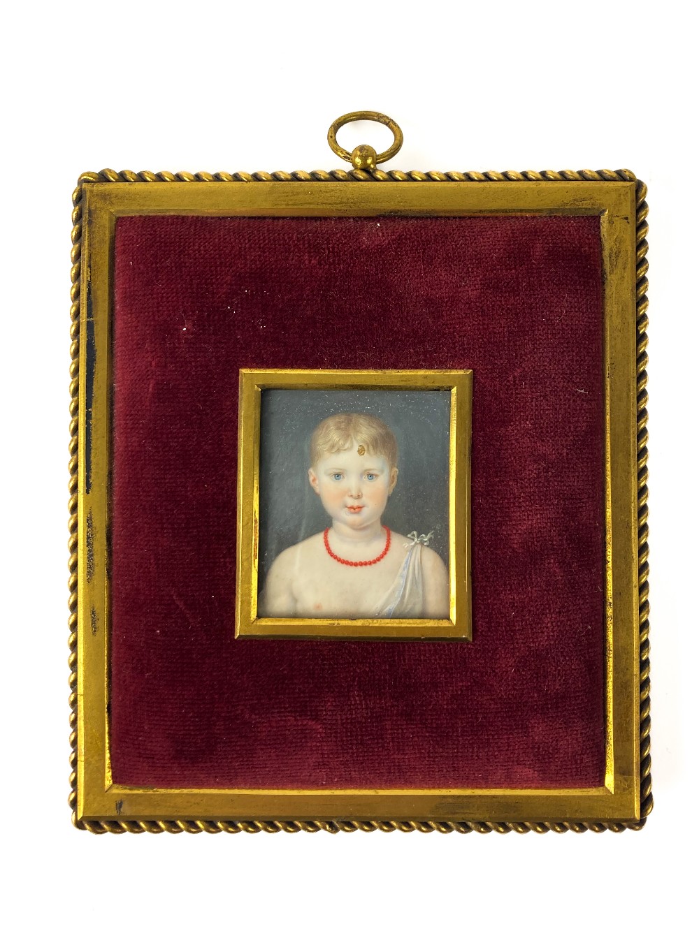 A 19th Century Miniature Portrait of a Young Lady, with short blonde hair and coral bead