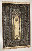 A fine Afghan Prayer Rug, the beige centre with two columns supporting an arch inside a multi-band