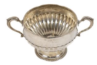 A heavy half fluted silver two handled Trophy Bowl, on circular stem base by the Goldsmiths &