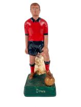 G.A.A.: a hand painted plaster Figure of a Footballer "Down", in standing position with foot on