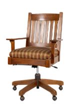 A good Stickley swivel Office Chair, with a six rail back and padded seat, with striped fabric on