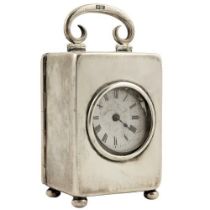 A miniature silver Carriage Clock, London 1912, with swing handle, lever movement and enamel dial