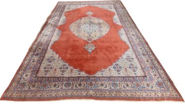 A very large burgundy ground Oriental wool Carpet, with large centre fawn floral medallion with