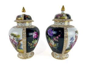 A pair of Dresden Vases and Covers, with black and white panels, each decorated with figures or