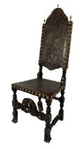 A 17th Century oak tall back leather and brass studded Chair.
