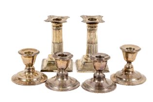 A pair of attractive silver Corinthian column design Bachelor Candlesticks, the shaped tops with