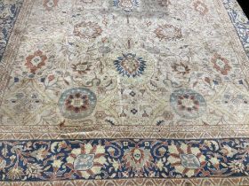 A fine quality Middle Eastern Carpet, the central panel with cream ground and bouquet of flowers