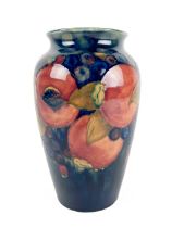 An attractive blue ground 'peach and blueberry' design Moorcroft Vase, stamped on base, approx.