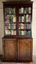 A George III period mahogany Bookcase, the moulded cornice above two astragal glazed doors on a base