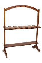 A mahogany Hat and Boot Rack, with arched top, tuned hangers, on splayed legs. (1) Provenance: Mr.