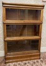 A globe Wernicke oak Bookcase, five sections with up and over glazed doors, all labelled on a