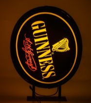 Advertisement: A large Vintage Guinness circular external wall mounted light up Advertisement