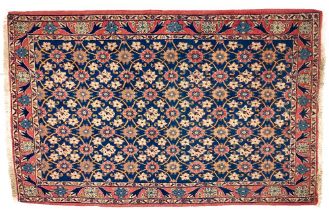 A fine quality Persian Rug, the floral field in navy blue with a series of ovals and half ovals