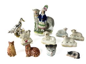 A Staffordshire Group, modelled with Woman and a Sheep as is, 20cms (8"); together with five smaller