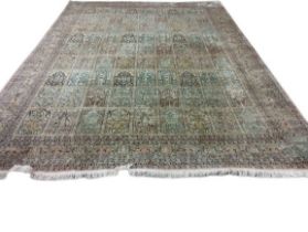 A magnificent pair of 20th Century silk Middle Eastern Carpets, the cream and rust ground with