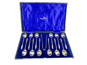 A cased set of 12 Apostle type Teaspoons, with matching Sugar Tongs, by Walker & Hall, Sheffield, in