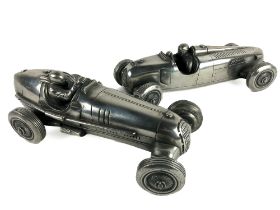 A pair of silvered metal models of Racing Cars, and drivers, each approx. 38cms (15") long. (2)