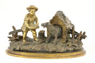 An attractive 19th Century gilt bronze Inkstand, modelled with a young boy feeding a dog by a kennel