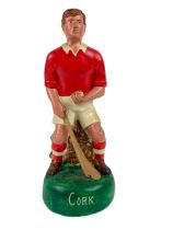 G.A.A.: a hand painted plaster figure of a hurler "Cork", in grouched position with sliotar and
