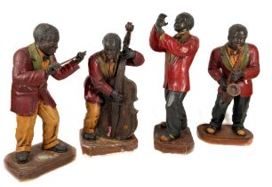 A set of four painted fibre glass Models, of a Miming Jazz Band, half life size, on plinth base. (4)