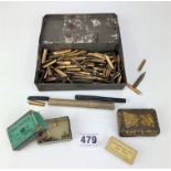 Tin of pen nibs and paper fasteners