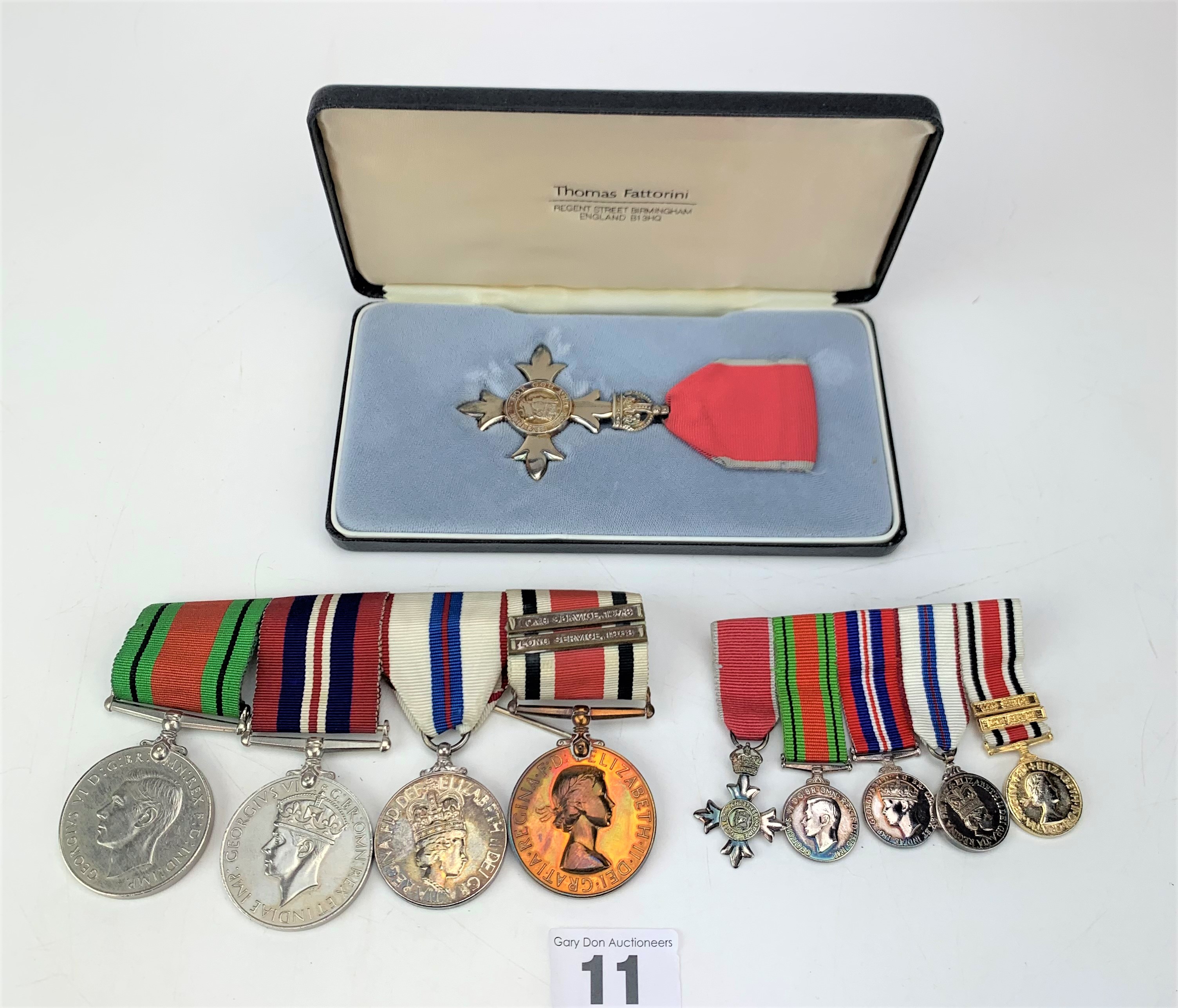 Bar with 2 Second World War Medals and 2 Police Service Medals, miniature medals and MBE medal