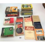 Assorted books on cameras and photography and instruction manuals